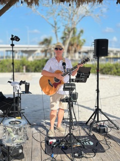 Michael McCormick performing on a beachfront boardwalk