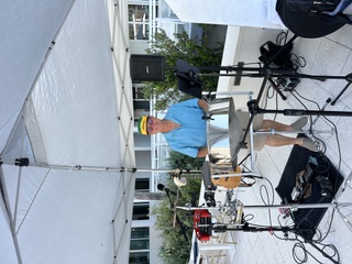 Michael McCormick playing steel drum at a poolside event